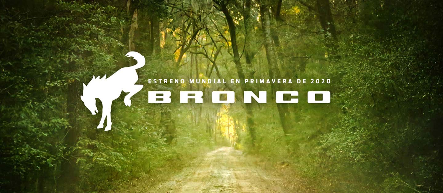 Long dirt road through a high planes vista with Bronco logo overlayed