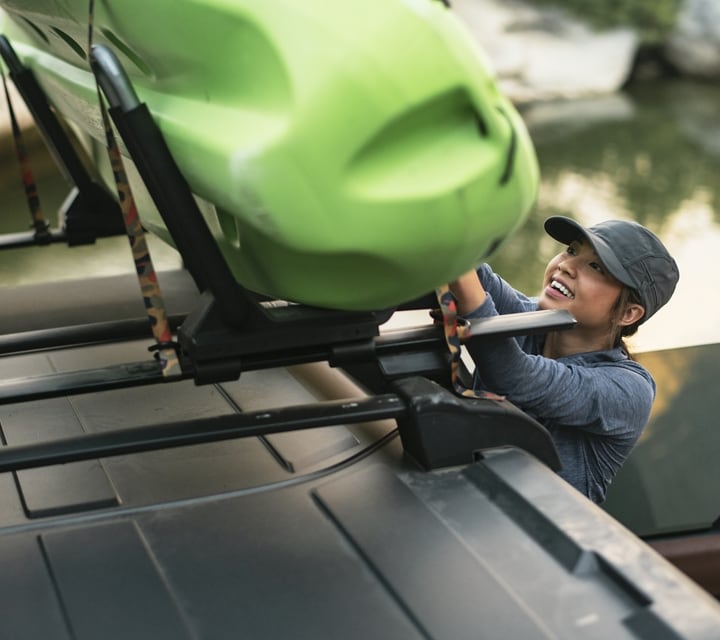 Primer plano de una mujer cargando un kayak en el techo de una Ford Bronco® 2024