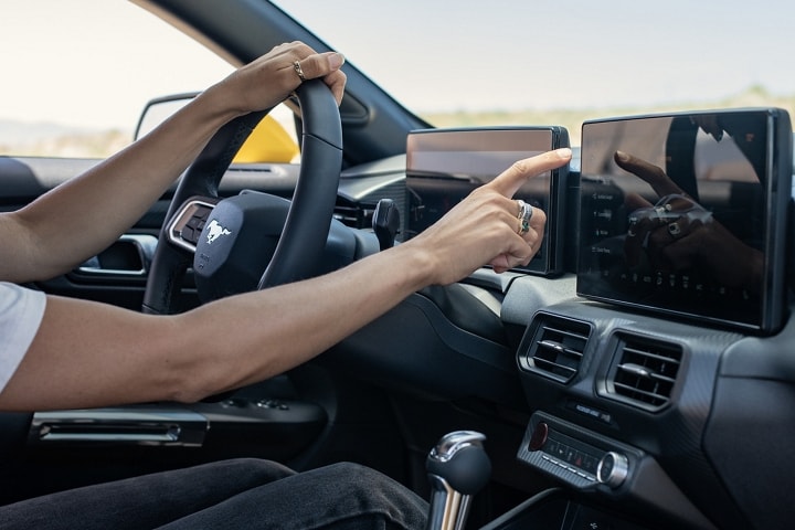 Un conductor usando la pantalla táctil del Ford Mustang® 2024